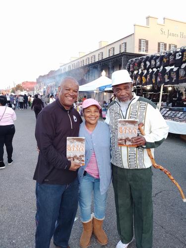 Tourists with book written by J.L. Chestnut