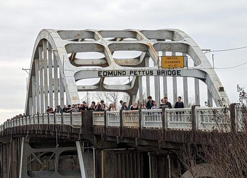 Visitors walking acorss the Edmund Pettus Bridge