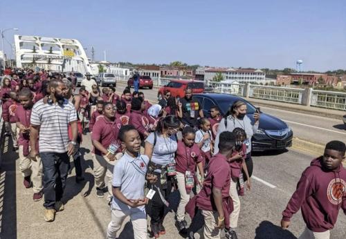 Georgia 7th grade students walking across the Edmund Pettus Bridge